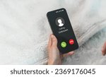 Small photo of Human use smartphone with incoming call from unknown number, spam, prank caller, hoax person, fake identity, scammer, scam with mobile phone, hacker, call center, crime, call, fraud or phishing