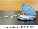Small photo of Personal CD player. Old portable cd player with open blue cover; cd inside