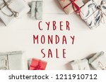 Cyber monday sale text. Wrapped present boxes on white wooden background top view. Seasonal greetings. Black friday sale