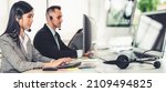 Small photo of Business people wearing headset working in office to support remote customer or colleague. Call center, telemarketing, customer support agent provide service in broaden view .