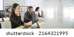 Small photo of Business people wearing headset working in office to support remote customer or colleague. Call center, telemarketing, customer support agent provide service in broaden view .