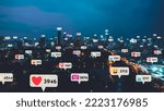 Small photo of Social media icons fly over city downtown showing people reciprocity connection through social network application platform . Concept for online community and social media marketing strategy .