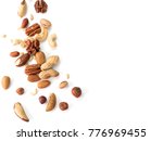 Background of nuts - pecan, macadamia, walnut, almonds, hazelnuts, and other - with copy space. Isolated one edge. Top view or flat lay