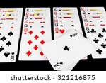 Playing cards being used for solitaire on black background