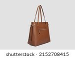 Side view on Brown Leather bag Handbag for women with long strap Hanging Isolated on White Background