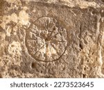 Very old engraving on Maltese church wall, inscribed markings in shape of a wheel 