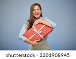 Happy woman holding big red gift box for present. Isolated female portrait.
