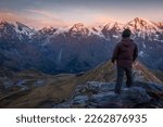 Hiker above Hohe Tauern mountain range dramatic Grossglockner road, Austria