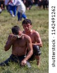 Small photo of EDIRNE, TURKEY - JULY 14, 2018 : Middle weight wrestlers battle for victory at the Kirkpinar Turkish Oil Wrestling Festival in Turkey. (wrestler turkish mean is pehlivan or guresci)