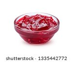 Small glass bowl of red berry jam isolated on white background, sweet cherry jam