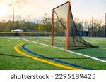 Small photo of Late afternoon photo of a lacrosse goal on a synthetic turf field before a night game.