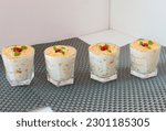 Small photo of Delicious trifle or tipsy pudding in glass topped with cherry.