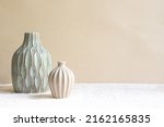Duo of vases on a beige...