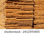 Small photo of Wooden timber at a sawmill. Piles of wooden boards in the sawmill. Industry.