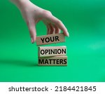 Small photo of Your opinion matters symbol. Wooden blocks with words Your opinion matters. Beautiful green background. Businessman hand. Business and Your opinion matters concept. Copy space.
