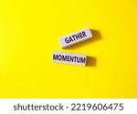 Small photo of Gather momentum symbol. Wooden blocks with words Gather momentum. Beautiful yellow background. Business and Gather momentum concept. Copy space.