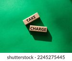 Small photo of Take charge symbol. Wooden blocks with words Take charge. Beautiful green background. Business and Take charge concept. Copy space.