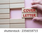 Small photo of Cover Letter symbol. Concept word Cover Letter on wooden blocks. Businessman hand. Beautiful pink background. Business and Cover Letter concept. Copy space