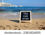 Small photo of Tell your story symbol. Concept words Tell your story on black chalk blackboard. Beautiful sea background. Business and Tell your story concept. Copy space.