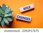 Small photo of Role changes symbol. Concept words Role changes on wooden blocks. Beautiful orange background with succulent plant. Business and Role changes concept. Copy space.