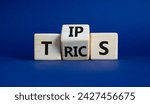 Small photo of Tips and Tricks symbol. Wooden cubes with words Tricks and Tips. Beautiful deep blue background. Business and Tips and Tricks concept. Copy space
