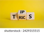 Small photo of Tips and Tricks symbol. Wooden cubes with words Tricks and Tips. Beautiful yellow background. Business and Tips and Tricks concept. Copy space