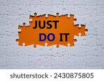 Small photo of Just do it symbol. Concept words Just do it on white puzzle. Beautiful orange background. Business and Just do it concept. Copy space.