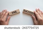 Small photo of Fail or Succeed symbol. Concept word Fail or Succeed on wooden blocks. Businessman hand. Beautiful white background. Business and Fail or Succeed concept. Copy space