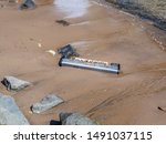 Small photo of New York, USA. Abandoned pianola or brought from the waters of the Hudson river on a beach of the Dumbo district. Environmental pollution. Act of vandalism. Lack of respect for the environment