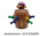 Small photo of Pirate barrel pop up toy for playing lucky stab challenge with plastic knives on isolated white background.
