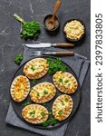 Small photo of Karelian pasties, karelian pies, pirogs, karjalanpiirakka, classic Finnish pastries of thin rye crust with rice filling, topped with butter mixed with chopped-up boiled eggs on plate, vertical view