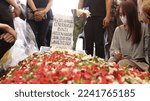 Small photo of The public cemetery complex (TPU) at Karet Bivouac, people making pilgrimages, funeral officials, people sowing flowers. Jakarta-Indonesia-December 2022.