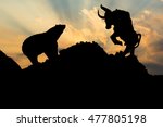 The silhouette of a bear and bull.