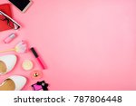 Beautiful flatlay with white flats, mobile phone, cosmetics and other accessories. Pink background, copyspace