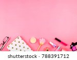 Beautiful flatlay with white planner, glasses, cosmetics and other accessories. Pink background, copyspace