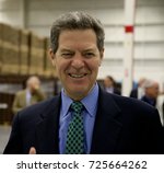 Small photo of Emporia, Kansas, USA, 8th April, 2015 Kansas Gavernor Sam Brownback today at the Hostess Twinkie plant in Empoira.