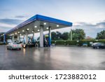 Abstract blur photo of car refueling on gas station at sunset. Pump gasoline gauge oil in the evening. This photo can be used for automotive service industry or unleaded transportation concept