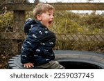 Small photo of An angry wild child boy screams at the camera, ready to fight. Tantrums and disobedience crisis of three years and self-isolation, quarantine.