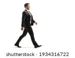 Full length profile shot of a businessman walking isolated on white background