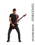Full length portrait of a guy playing an electric guitar isolated on white background