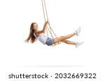 Beautiful girl with long hair swinging on a wooden swing isolated on white background