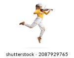 Full length shot of a modern female artist dancing and playing a violin isolated on white background 