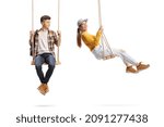 Male teen sitting on a swing and looking at a young female swinging isolated on white background