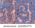 This image shows panel details from the V bar V Ranch Heritage Site in Arizona.  The petroglyphs were chipped into a sandstone rock face by Sinagua peoples and depict birds, animals, and people.  