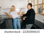 Small photo of Portrait of angry jealous wife scolding, raising voice, gesturing with hands, yelling at ignoring tired boyfriend standing in kitchen. Concept of family scandal, crisis, domestic violence, abuse.