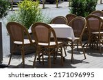 Empty restaurant chairs with no people to use them and an ashtray on table. Horeca industry businesses failing during pandemic times