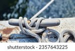 Small photo of Metal cleat on a wooden dock. Cleats are used for securing docks and lines from boats