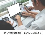 Small photo of Business man is using the laptop with muck up white screen