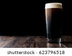 Dark Beer On Wooden Surface....