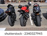 Small photo of July 30, 2023: Three Motorcycles with slick tires stand side by side on street at the Nautical Mile in Freeport New York.